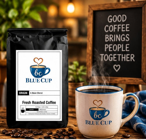 Blue Cup 6 Bean Blend coffee bag with steaming branded mug and roasted coffee beans