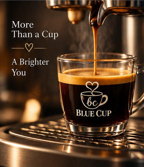 Fresh espresso brewing into a Blue Cup branded glass